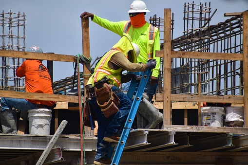 construction safety pic 5 July 15, 2021 | Construction workers wear protective masks and withstand extremely hot temperatures, amidst the covid-19 pandemic in Houston Texas
